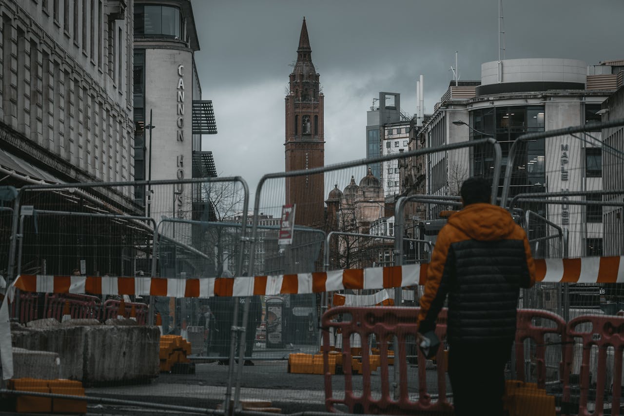 services-02 A moody street scene featuring construction barriers and architecture in Birmingham, UK.